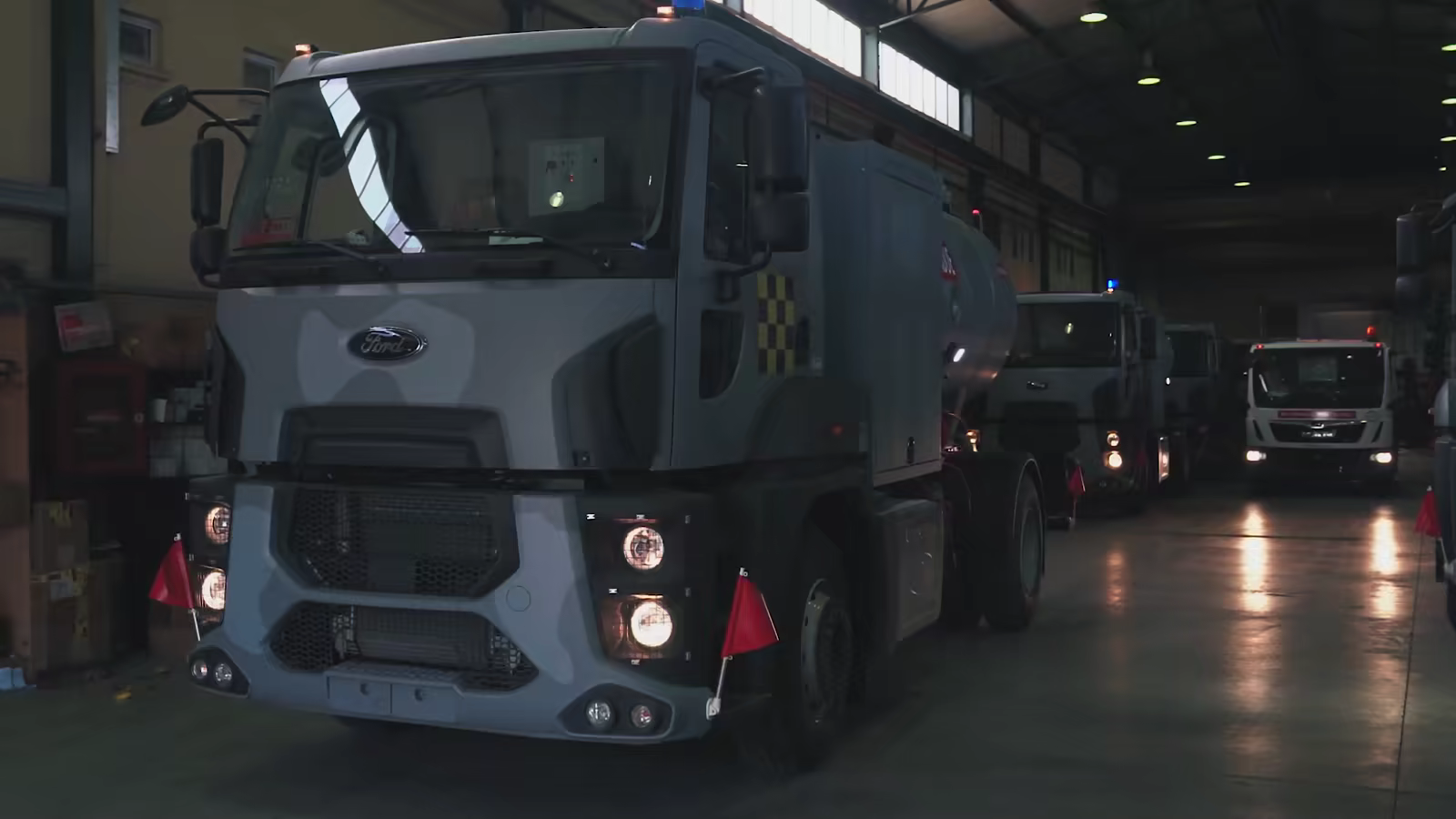 Refuellers with headlights on inside the MATEŞ production hall