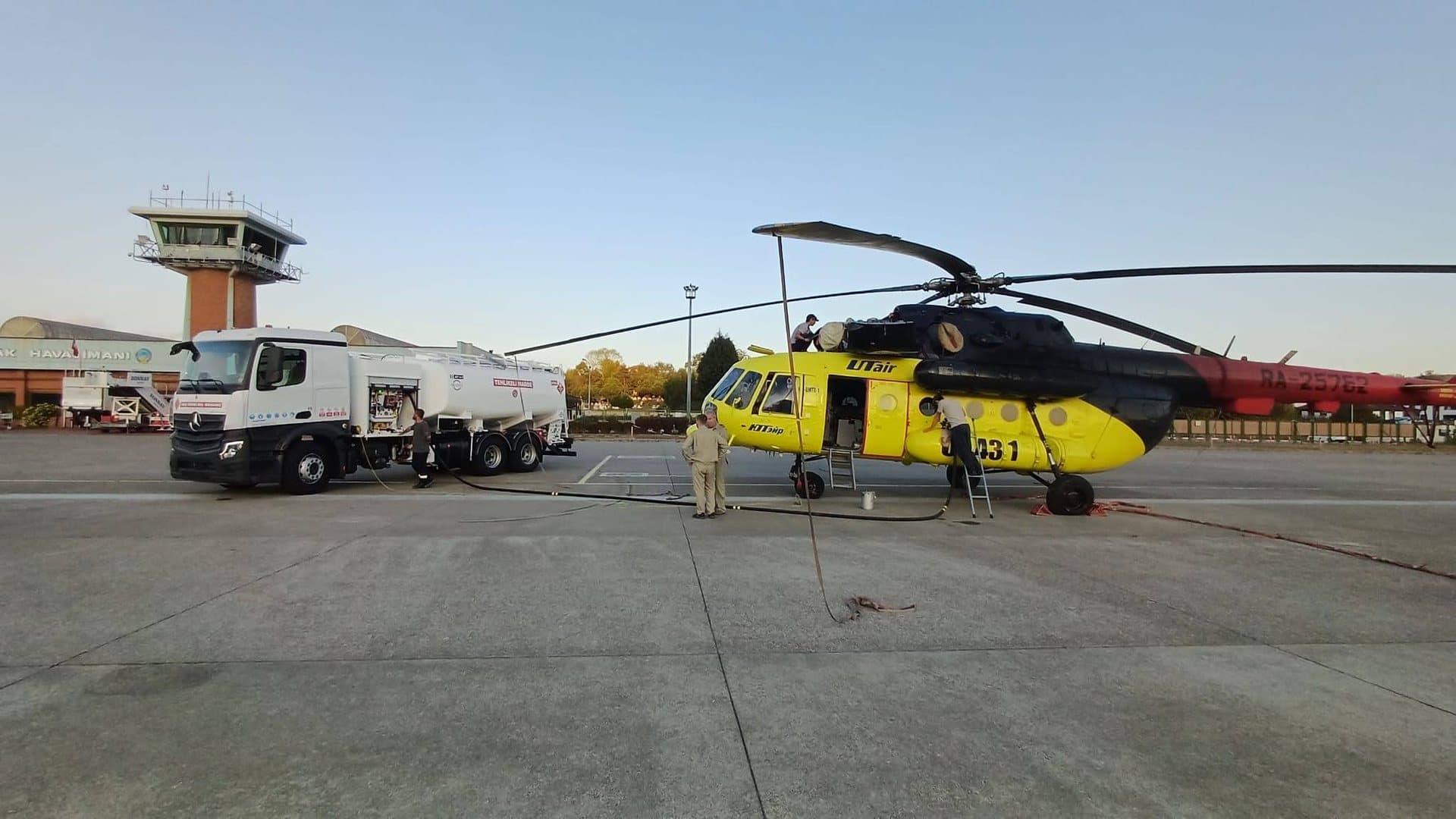 MATEŞ rigid refueller fuelling a Mi-8 helicopter next to the airport control tower